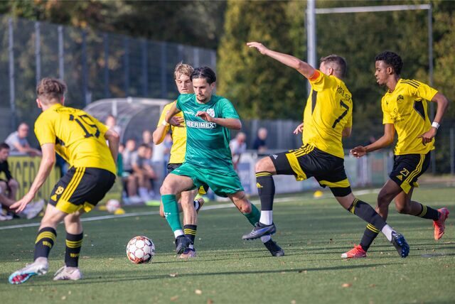 Kaiseraus Kapitän Lukas Schuster (Nummer 7) geht zum Ball.