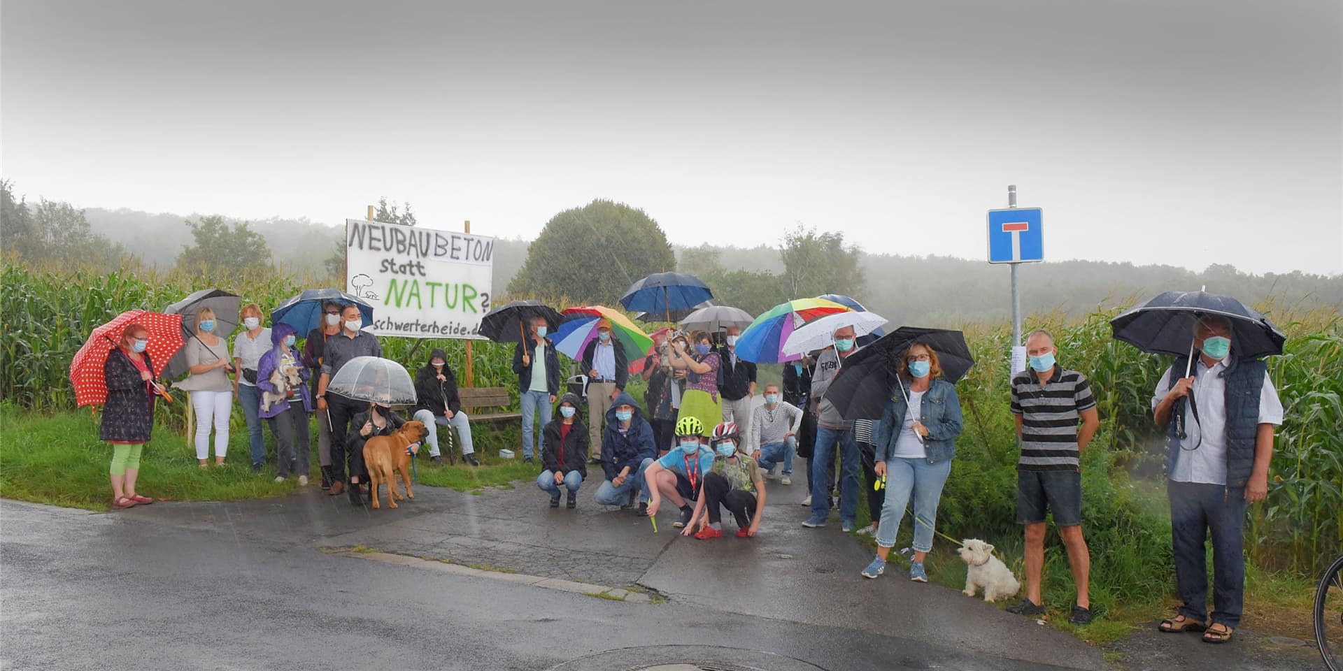Trotz strömenden Regens trafen sich die Bürgerinitiative Schwerterheide und Interessierte am Sonntagnachmittag am Feldrand an der Ecke Waldstraße/Kornweg. Weitere Aktionen sind geplant.