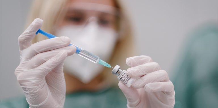 Eine Mitarbeiterin im Gesundheitswesen zieht im Impfzentrum des Rossmann Konzerns eine Spritze einem Covid-19 Impfstoff auf.