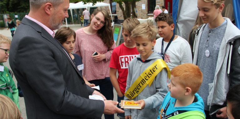 Bei „Lünopoli“ lernen Kinder, wie eine Stadt funktioniert – und übernehmen selbst Verantwortung von den „Großen“, wie hier von Bürgermeister Jürgen Kleine-Frauns.