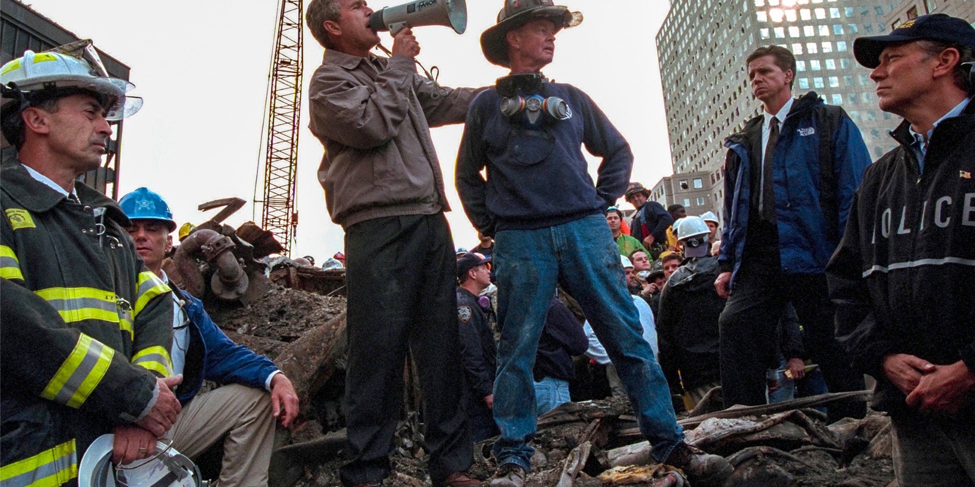 US-Präsident George W. Bush (M,l), spricht in den Trümmern des New Yorker World Trade Centers neben dem pensionierten New Yorker Feuerwehrmann Bob Beckwith zu den freiwilligen Helfern und Feuerwehrleuten durch ein Megafon.