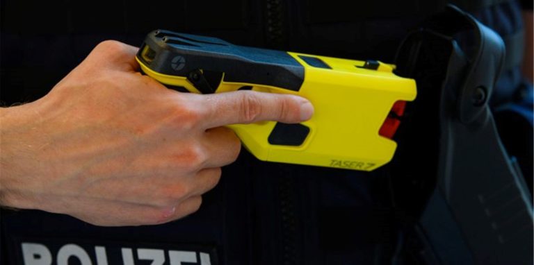 Ein Polizeibeamter präsentiert einen Taser.