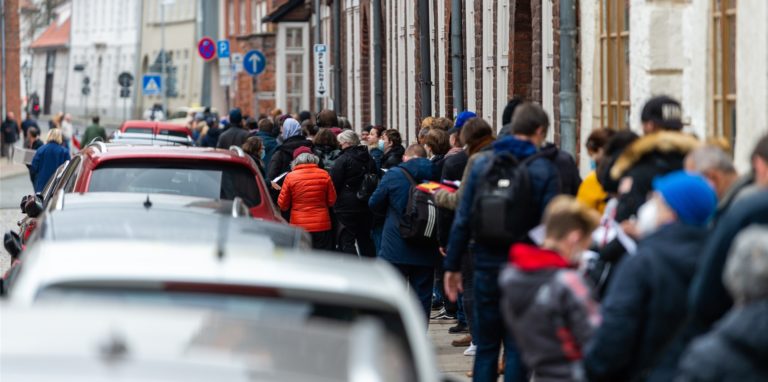 Lange Menschenschlange vor einer Impfstelle: Starke Einschränkungen für Ungeimpfte können auch zur Entscheidung für die Schutzimpfung gegen Covid-19 beitragen.