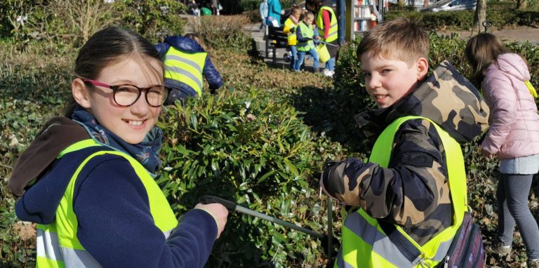 Mit Greifzangen holten die „Müllsammler“ aus Holzwickede den Unrat auch aus dem dichtesten Strauchwerk, wie hier zwischen Edeka-Markt und Parkplatz.