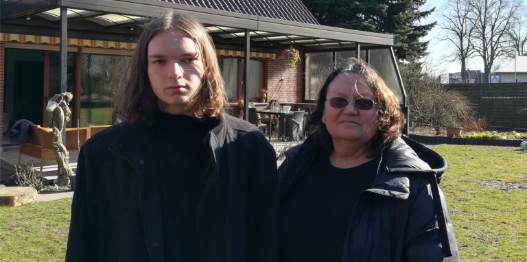 Kateryna Khokhlvkhina steht mit ihrem Sohn Kolya auf einer Wiese