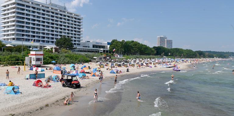 Besucher bevölkern den Strand der Ostsee.