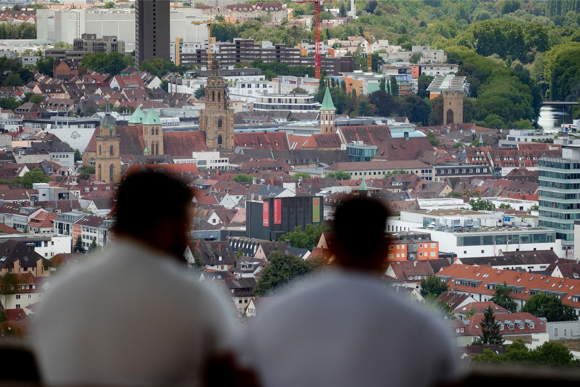 Zwei junge Männer genießen auf dem Wartberg den Blick auf die Stadt.