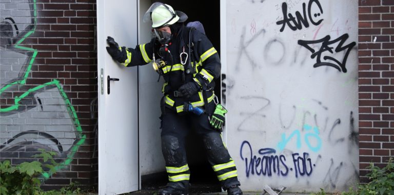 Ein Feuerwehrmann kommt nach den Löscharbeiten aus dem Stellwerk am Hauptbahnhof in Lünen.