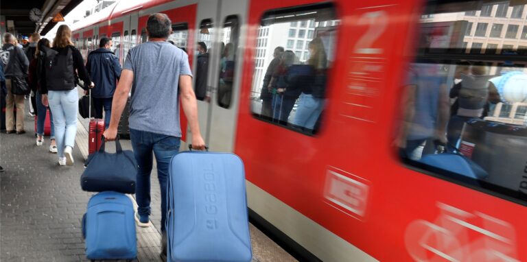 Bahnfahrer drängen sich am Eingang eines Regionalzuges am Deuter Bahnhof.