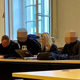 Anwälte und Angeklagte im Gerichtssaal.