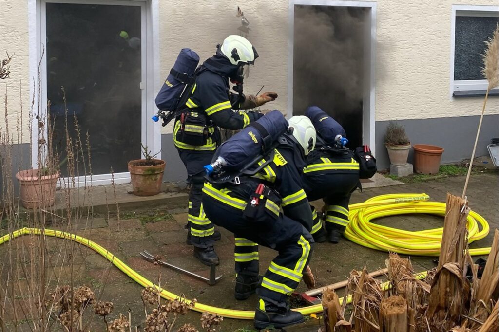 Feuerwehrleute löschen einen Brand Feuerwehrleute löschen einen Brand