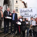 Viele Menschen mit einem Plakat auf dem „Erhaltet das Schürenfeld“ steht stehen vor dem Fröndenberger Rathaus. Zu sehen sind außerdem Andreas Hennemann, Initiator der Bürgerinitiative, und der damalige Bürgermeister Fritz Rebbe.