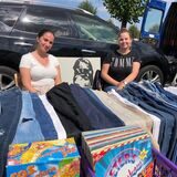 Zwei Frauen sitzen beim Trödelmarkt auf dem Globus-Gelände in Unna an ihrem Stand.