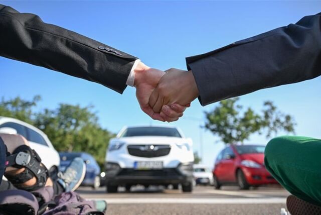 Mitglieder der Protestgruppe Letzte Generation nehmen an einer Sitzblockade an der Autobahnabfahrt am Elbepark in Dresden teil.