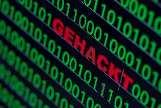Zwischen dem Binärcode auf einem Laptopmonitor steht das Wort «gehackt» geschrieben.
