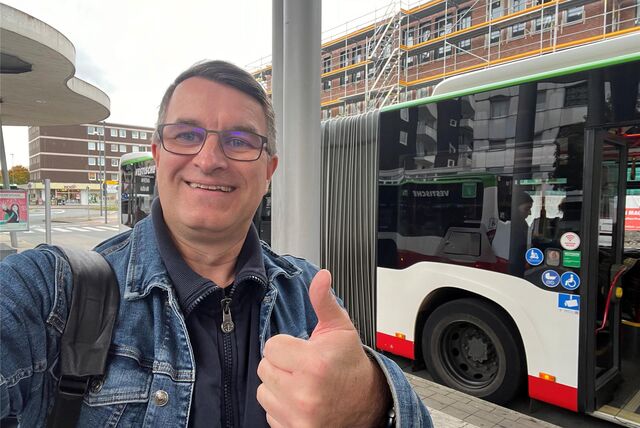 Ein Mann zeigt am Busbahnhof in Herten-Mitte mit dem Daumen nach oben.
