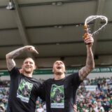 Joel Grodowski hält eine Bierflasche in der Hand.