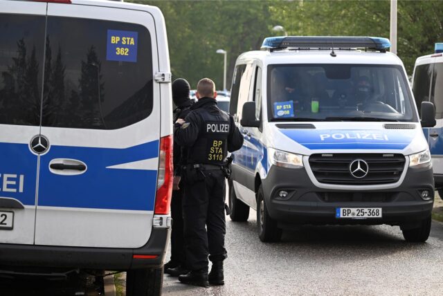Polizisten durchsuchen Wohnungen und Häuser im Rahmen einer Razzia gegen Schleuserkriminalität.