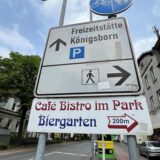 Schilder und Wegweiser hängen an der Friedrich-Ebert-Straße in Unna. Sie weisen hin auf die Freizeitstätte Königsborn und das geschlossene Café Bistro.