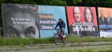 Ein Radfahrer fährt an Großplakaten von FDP, CDU, SPD und Freien Wählern zur Europawahl vorbei.