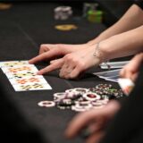 Ein Tisch, auf dem Karten gespielt werden. Daneben liegen Casino-Chips.