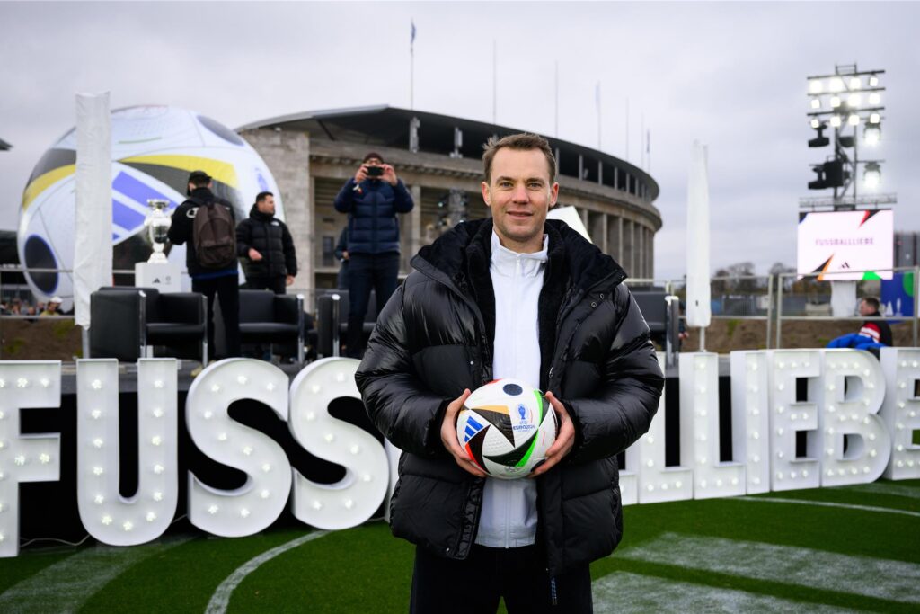 Nationaltorwart Manuel Neuer steht vor einem Schriftzug Nationaltorwart Manuel Neuer steht vor einem Schriftzug