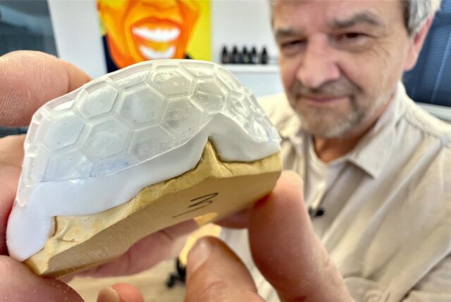 Martin Thaden von der Dreve Dentamid GmbH in Unna zeigt einen Mundschutz auf einem Gebissmodell.