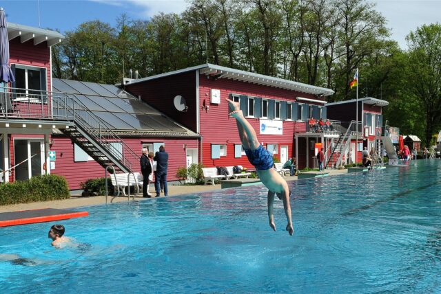 Ein Junge springt ins Becken des Elsebades beim Anbadefest im Jahr 2024.
