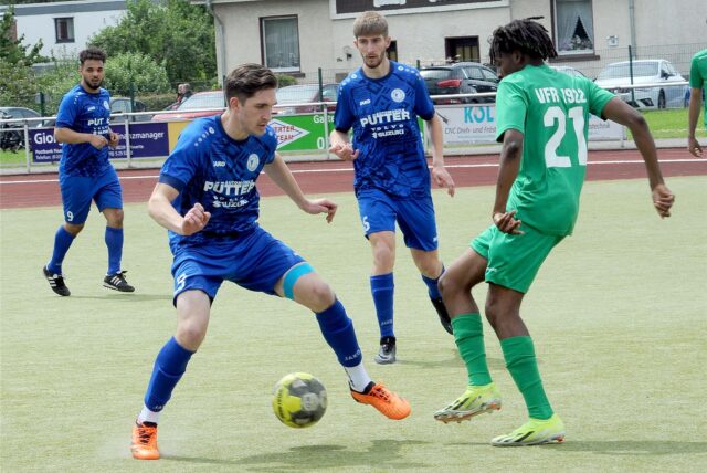 Ein Spieler versucht den Ball gegen seinen Gegner zu behaupten.