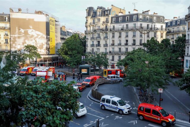 Polizisten und Feuerwehrleute stehen neben Rettungsfahrzeugen in der Nähe der Bar „Le Ramus“, wo ein Autofahrer in Paris auf die Terrasse eines Cafés fuhr und mehrere Verletzte hinterließ.