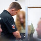 Angeklagte bekommt Handschellen von einem Wachmann abgenommen.