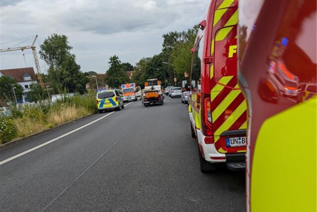 Mehrere Feuerwehrwagen und Polizei auf einer Straße.