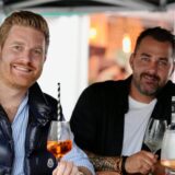 Zwei Gäste auf der Gourmedo 2024 trinken aus schicken Gläsern.
