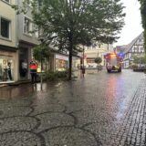 Ein Feuerwehrauto fährt durch die Fußgängerzone in Unna. Äste liegen auf dem Boden.