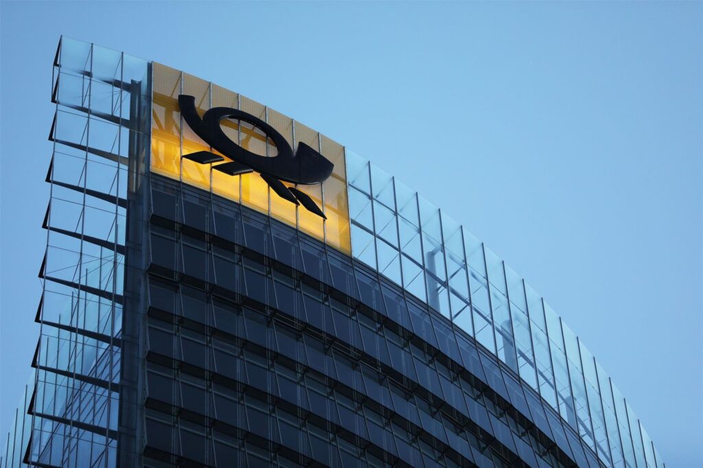Das Logo der Deutschen Post leuchtet am Post-Tower, dem Unternehmenssitz des Post-Konzerns DHL.