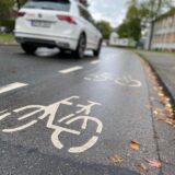 Ein Auto fährt neben dem Radweg vor dem RTG in Schwerte.