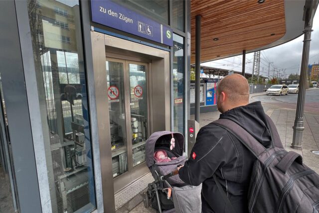 Ein Mann mit einem Kinderwagen steht am Bahnhof Unna vor dem Aufzug