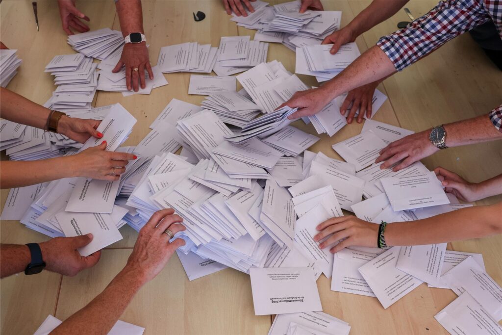 Zahlreiche Wahlhelfer nehmen sich bei der Stimmenauszählung die Umschläge mit den Briefwahlstimmen zur Europawahl. Zahlreiche Wahlhelfer nehmen sich bei der Stimmenauszählung die Umschläge mit den Briefwahlstimmen zur Europawahl.