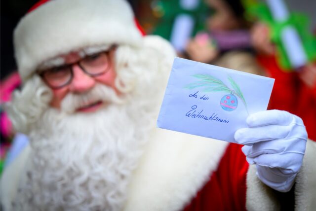 Der Weihnachtsmann steht vor dem Weihnachtspostamt und zeigt einen Brief mit einem Wunschzettel. Knapp sechs Wochen vor Heiligabend hat der Weihnachtsmann im brandenburgischen Himmelpfort wieder seine Wunschzettel-Filiale eröffnet.