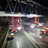 Eine Brücke der Deutschen Bahn wird am 8. Dezember 2024 nachts mit Hilfe von Baumaschinen in ihre Position über der A1 bei Unna gebracht.