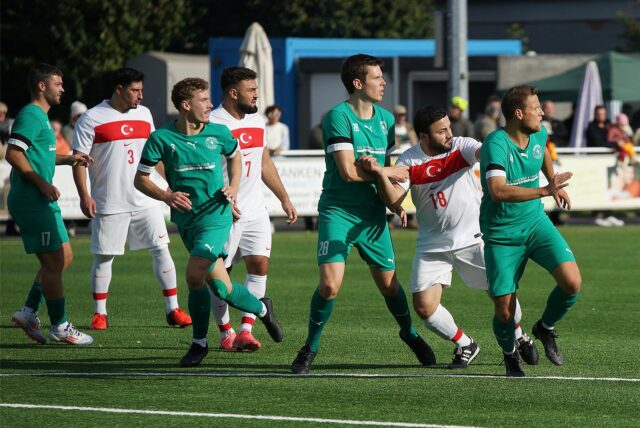 Spieler rangeln auf dem Fußballfeld.