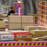 Pakete liegen im DHL-Paketzentrum auf einem Transportband (Aufnahme mit langer Verschlusszeit). In der Zeit vor Weihnachten erhöht sich das Paketaufkommen stark.