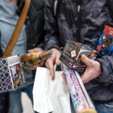 In einem Supermarkt halten Kunden Feuerwerk in den Händen