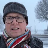 Reporter Carsten Fischer steht an der Chaussee in Holzwickede bei Schneefall.