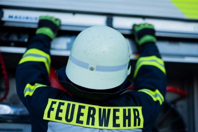 Ein Feuerwehrmann holt Equipment aus einem Einsatzfahrzeug an der Feuerwache der Feuerwehr.