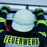 Ein Feuerwehrmann holt Equipment aus einem Einsatzfahrzeug an der Feuerwache der Feuerwehr.