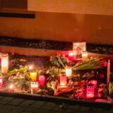 Eine Gedenkstelle mit Kerzen, einem Foto und Blumen an der Wohnung der Getöteten in Huckarde.
