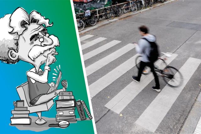Ein Mann schiebt sein Fahrrad über den Zebrastreifen.