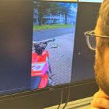 Das Tiktokvideo ist auf dem Bildschirm zu sehen. Es zeigt das Motorrad mit Donuts, im Hintergrund die Wache. Rechts neben dem Bildschirm ist der Hinterkopf des Redakteurs zu sehen.