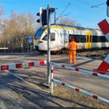 Auf der Bahnstrecke zwischen Werl und Unna steht am 18.2. ein Zug am Bahnübergang in Hemmerde. Ein Bahnmitarbeiter sichert den Bahnübergang ab.